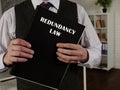 Book with title REDUNDANCY LAW . RedundancyÃÂ is when an employer reduces their workforce because a job or jobs are no longer